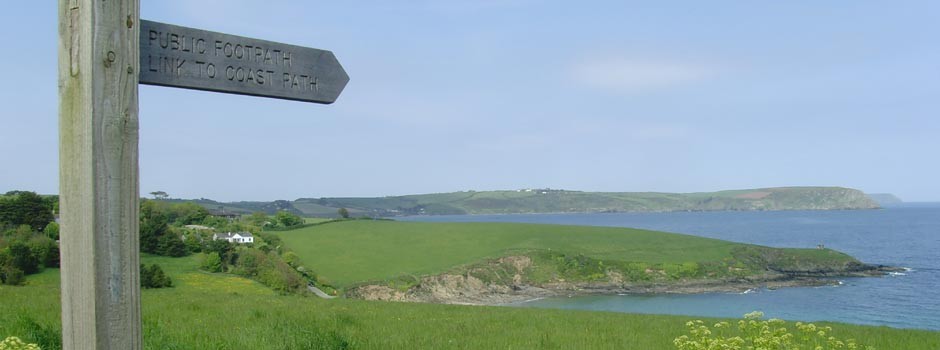 wooden signpost showing directions to coastal footpath at Portscatho